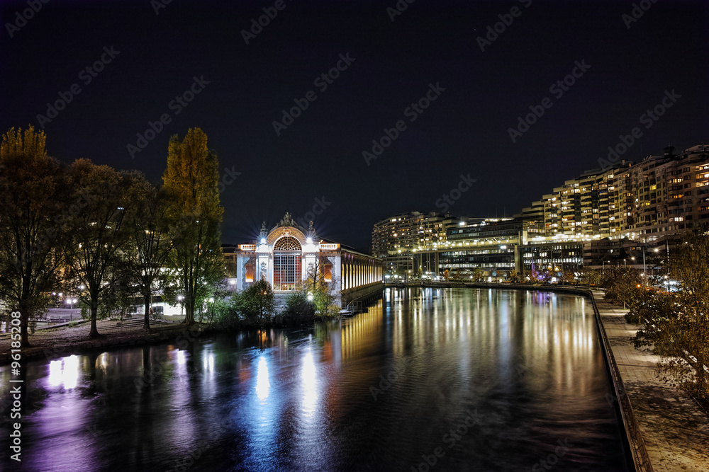 Night photo of Rhоne River and city of Geneva, Switzerland