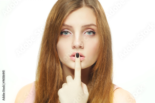 Beauty woman portrait with finger near lips. Isolated on white background.