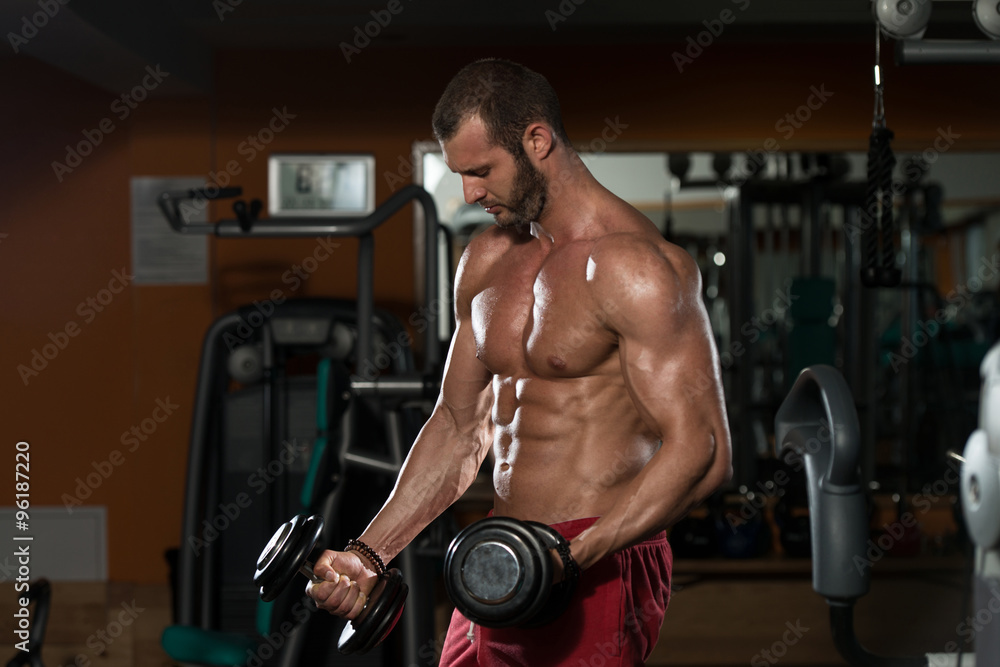 Healthy Young Man Doing Exercise For Biceps