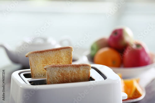 Served table for breakfast with toast and fruit, close-up