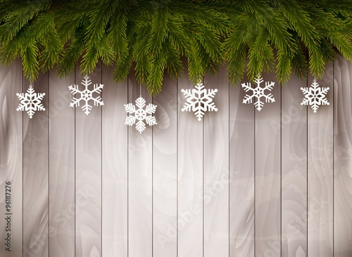 Background with Christmas tree branches and snowflakes in front