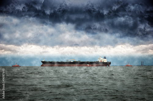 Ship on sea with dramatic sky at winter.