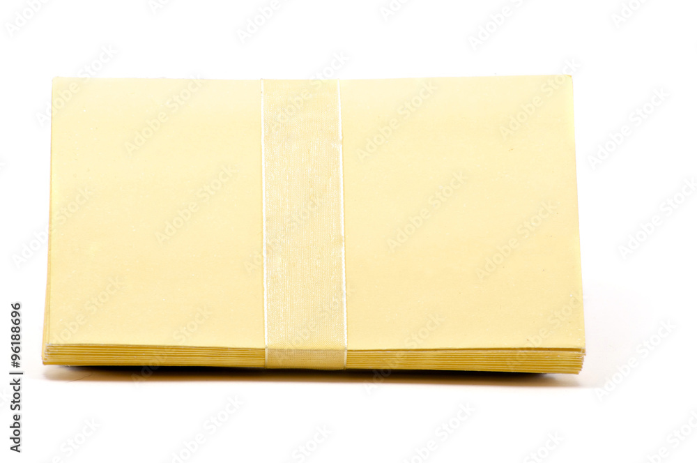 Stack of yellow greeting cards with ribbon Stack of yellow greeting cards with ribbon