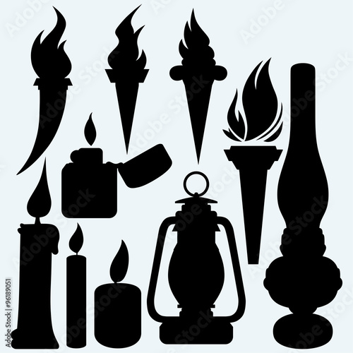 Hot stuff: candle, flaming torches, kerosene lamp and metal zippo lighter. Isolated on blue background. Vector silhouettes