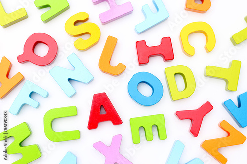 Rainbow Alphabet scattered on a white background