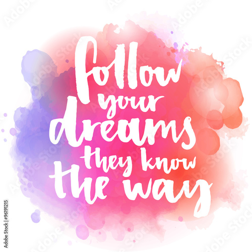 Follow your dreams, they know the way. Inspirational quote about life and love.  Modern calligraphy text, handwritten with brush on pink and orange watercolor splash background with bokehs