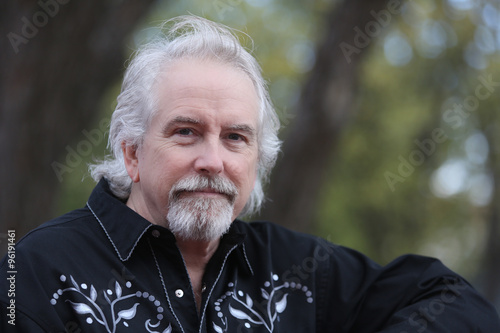 Outdoor portrait of determined compassionate mature male model