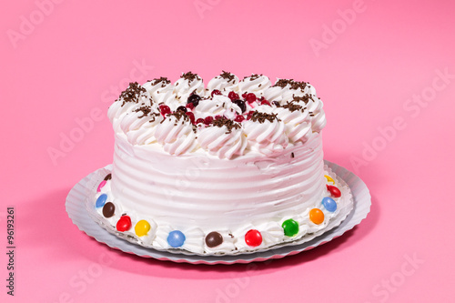Tasty creamy birthday cake colorful candy adorned