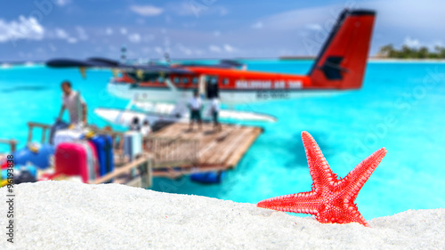 Wallpaper Mural combination of sandy and shell front with blurred tropical island Torontodigital.ca