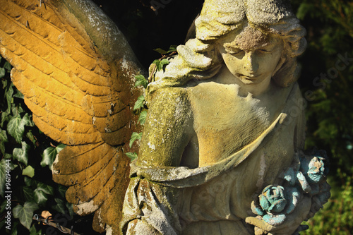 golden angel in the sunlight (antique statue)