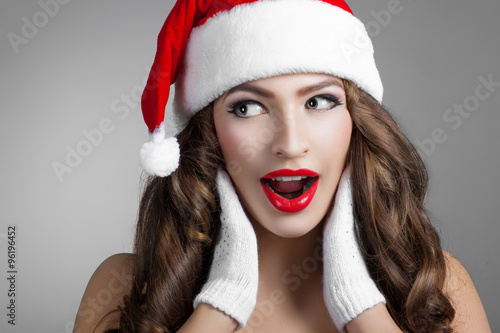 beautiful young woman in a Santa Claus hat.