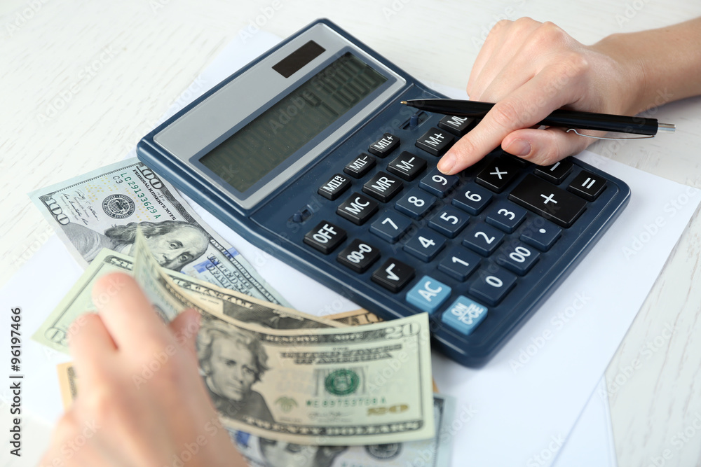 Accounting concept.Analyzing finance report with calculator Accounting concept.Analyzing finance report with calculator