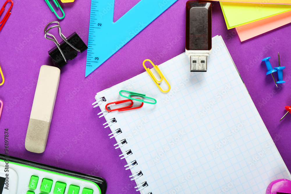 Office and student tools on purple background closeup Office and student tools on purple background closeup