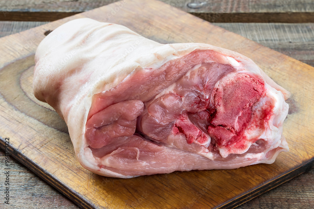 Raw pork knuckle on a cutting board