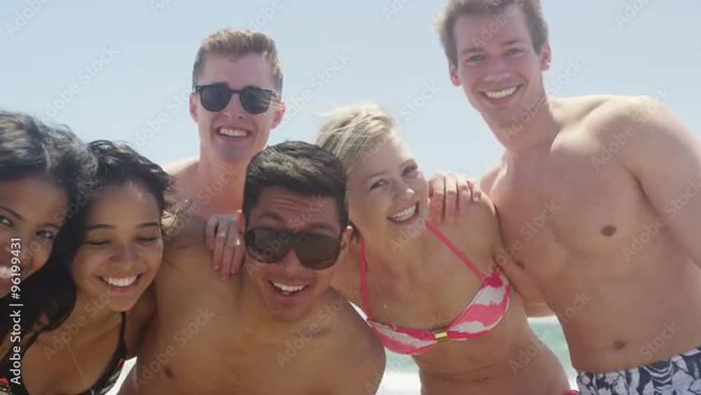 Portrait of young adult interracial group of friends smiling at camera Portrait of young adult interracial group of friends smiling at camera