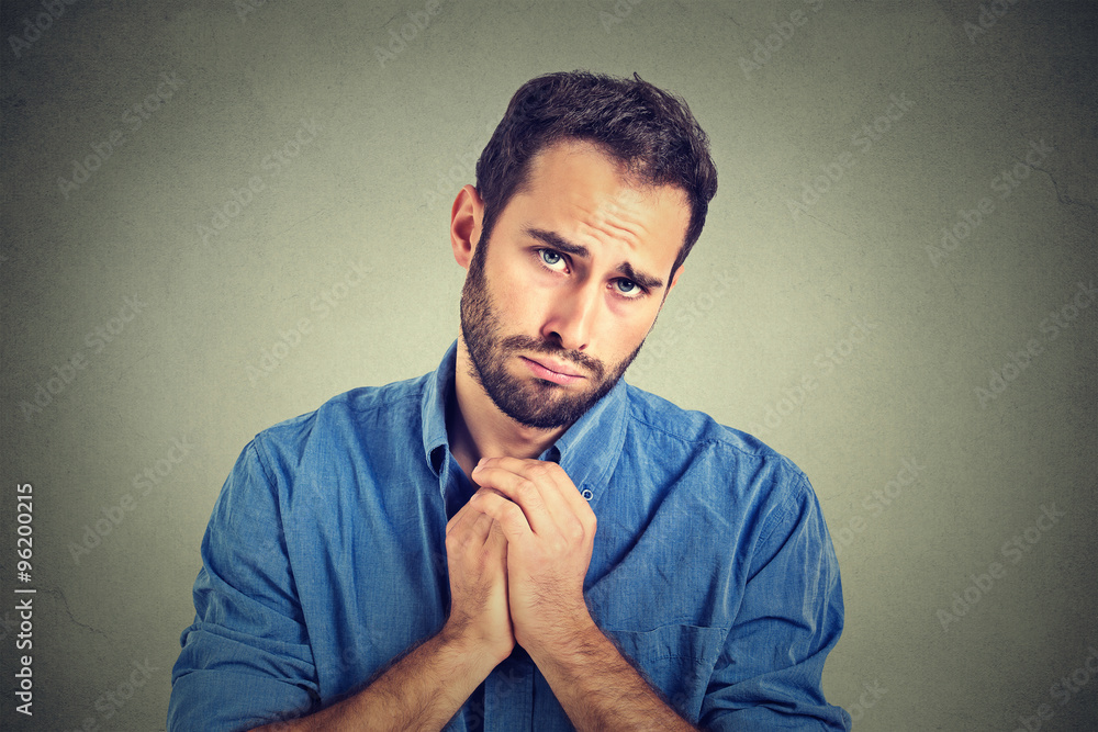 desperate young man showing clasped hands, pretty please asking help forgiveness desperate young man showing clasped hands, pretty please asking help forgiveness