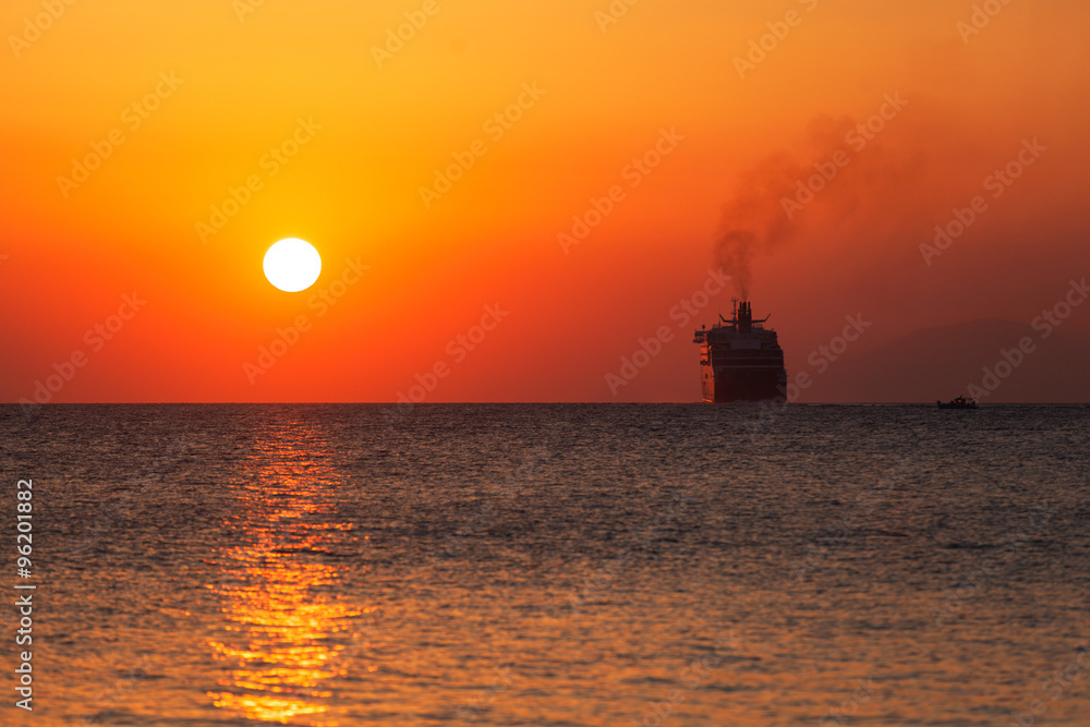 Silhouette of a ferry ship at sunrise