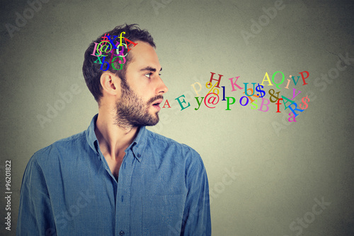 Foto man talking with alphabet letters in his head and coming out of open mouth