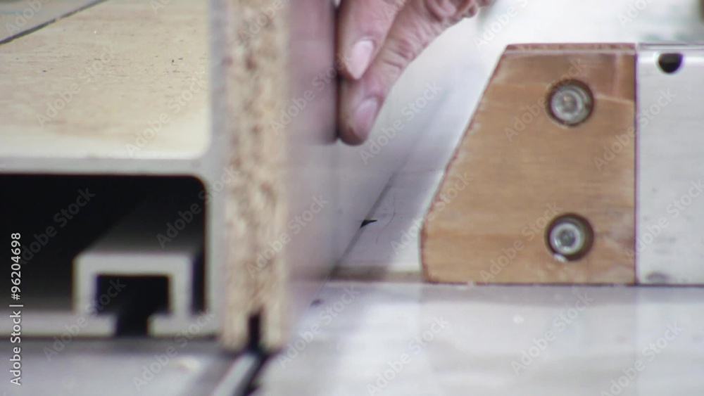 Man working on the cutting machine in furniture factory.
Man working on the cutting machine in furniture factory.