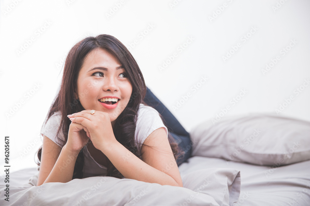 Woman laying on the bed thinking
