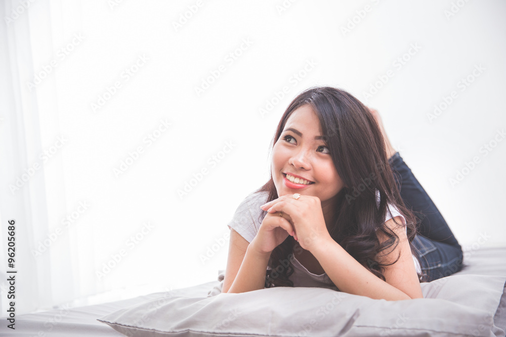 Woman laying on the bed thinking Woman laying on the bed thinking