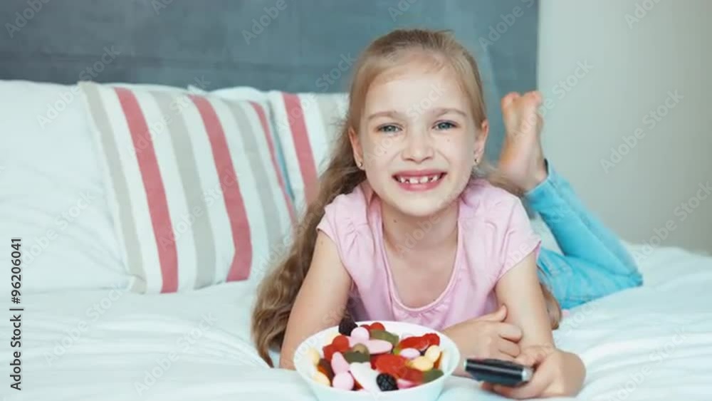 Laughing girl watching TV. Child shocked TV Laughing girl watching TV. Child shocked TV