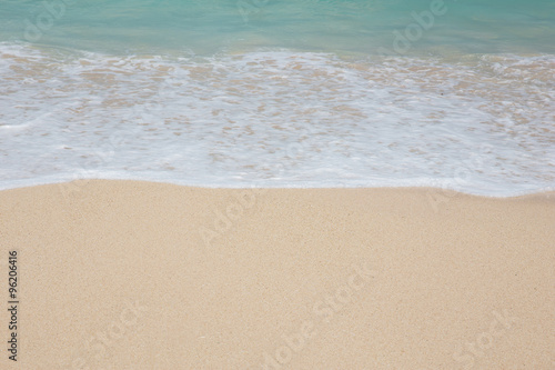 Close up of sand, water and wave on seashore