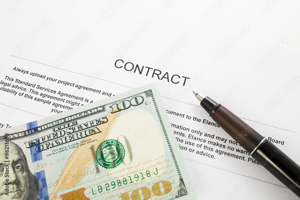Pen on the contract papers and us dollars Pen on the contract papers and us dollars