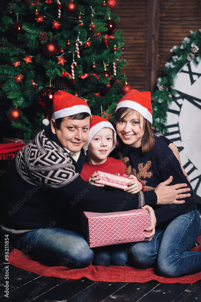 Christmas family of three persons in red hats Christmas family of three persons in red hats