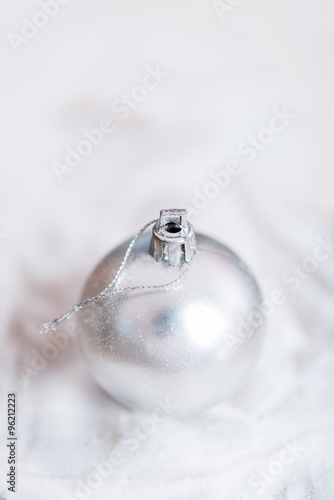 Shiny silver Christmas balls over snow background photo