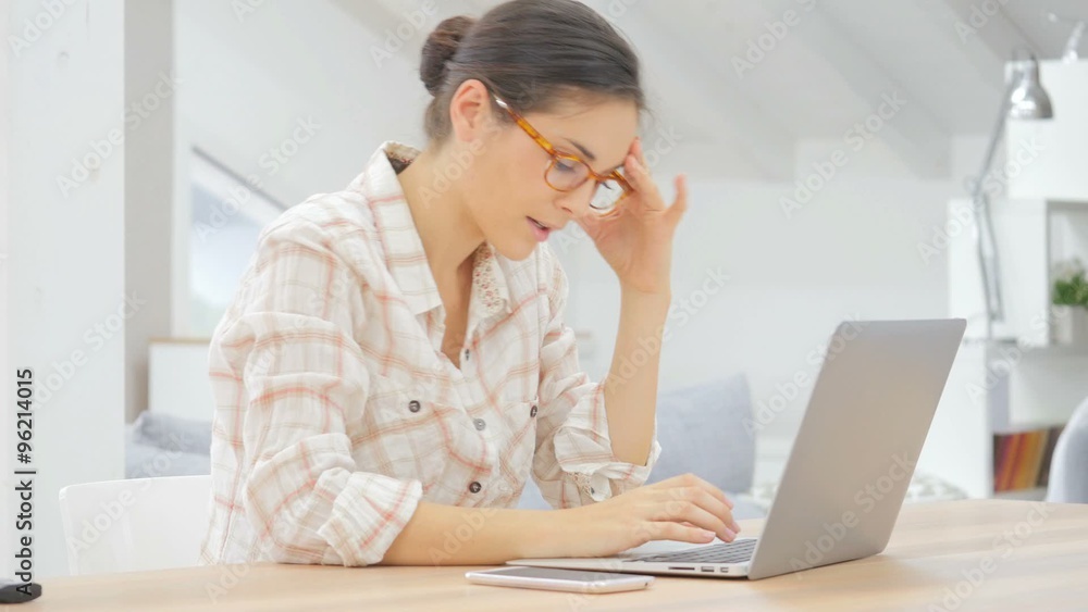 Woman working in laptop, having a headache Woman working in laptop, having a headache