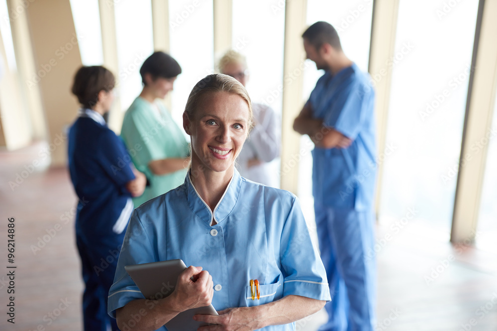 female doctor with tablet computer  standing in front of team