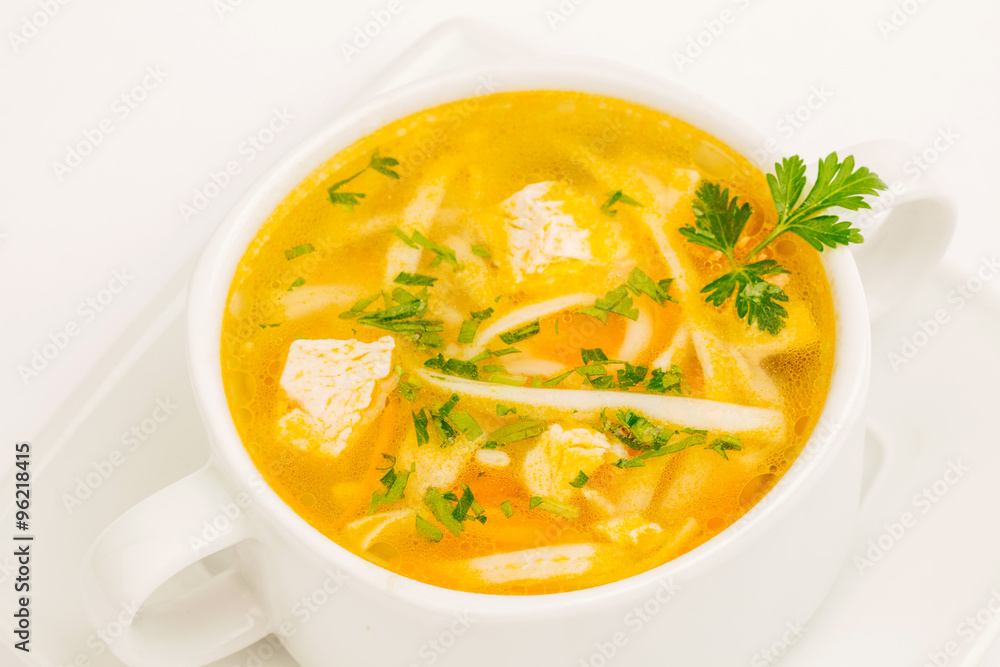 Chicken noodle soup in white mug Chicken noodle soup in white mug