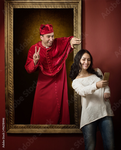 Alive portrait of a medieval priest and a visitor of the gallery taking selfie photo together