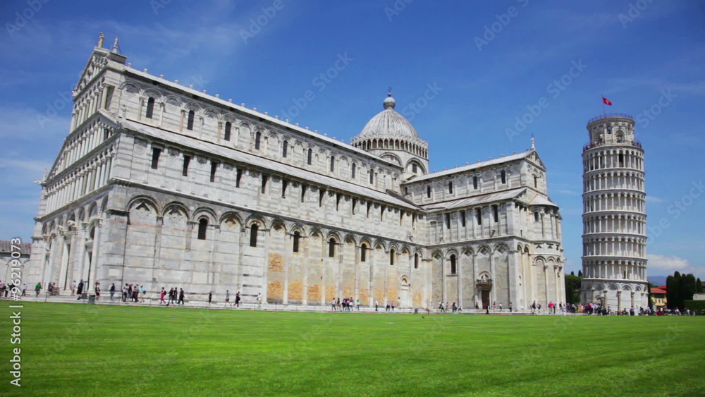 General view at leaning tower of The Piazza dei Miracoli (Piazza del Duomo) with many tourists under clear sunny sky in Tuscany. General view at leaning tower of The Piazza dei Miracoli (Piazza del Duomo) with many tourists under clear sunny sky in Tuscany.