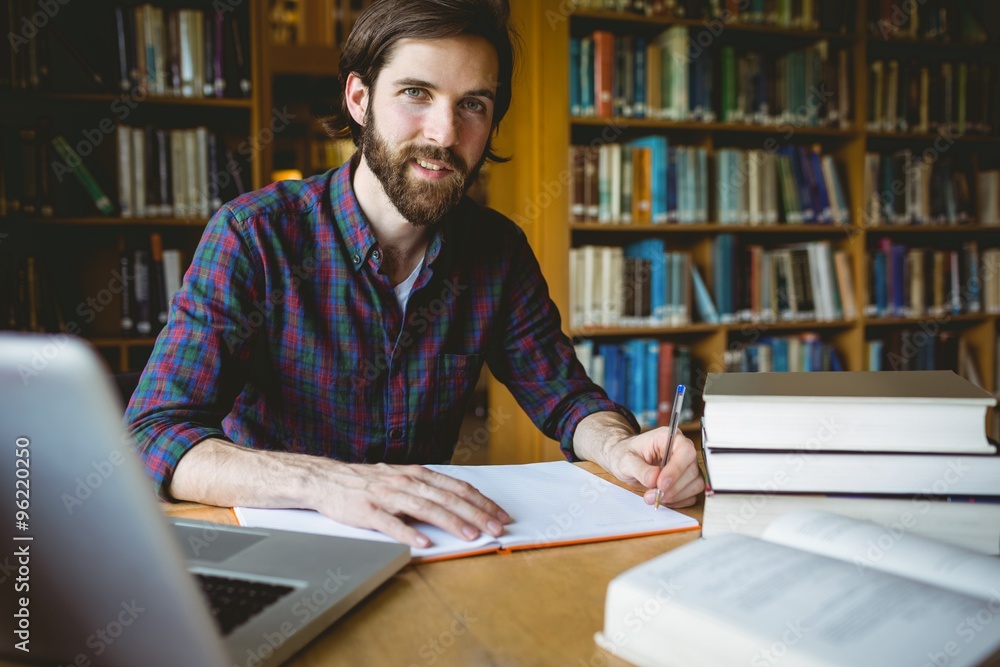 Hipster student studying in library Hipster student studying in library