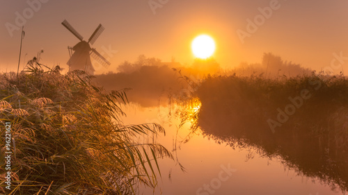 historic windmill on a foggy morning