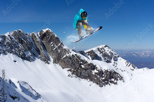 flying snowboarder on mountains