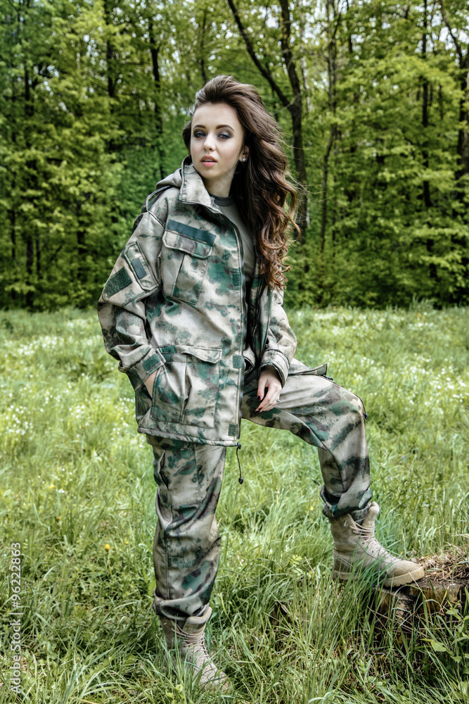 Beautiful army woman in military uniform outdoor