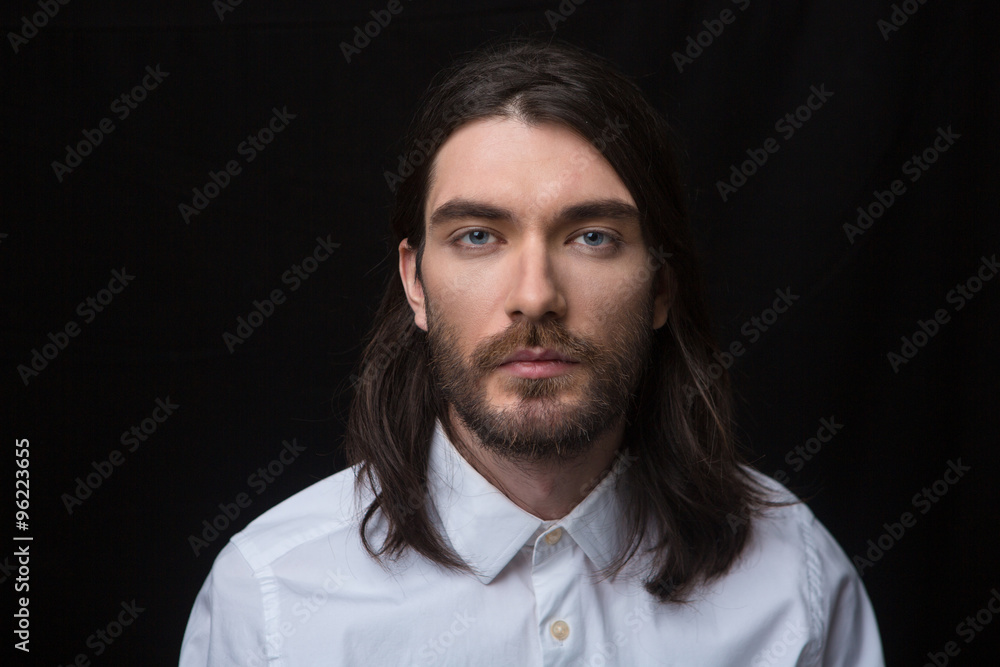 Man with beard and long hair looking at camera Man with beard and long hair looking at camera