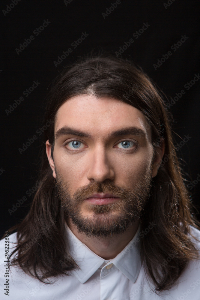 Man with beard and long hair looking at camera Man with beard and long hair looking at camera