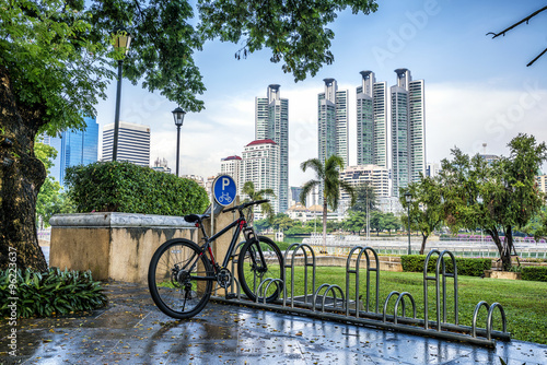 Bicycle parking rack in public park with modern building backgro