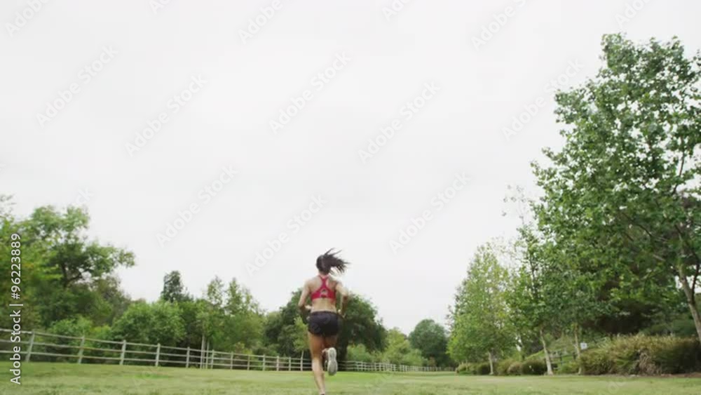 Healthy young Asian woman running and jumping at the park Healthy young Asian woman running and jumping at the park