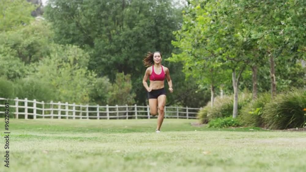 Healthy young Asian woman running slow motion at the park Healthy young Asian woman running slow motion at the park
