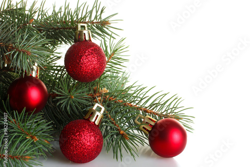 fir twigs with shiny Christmas decorations on a white isolated background