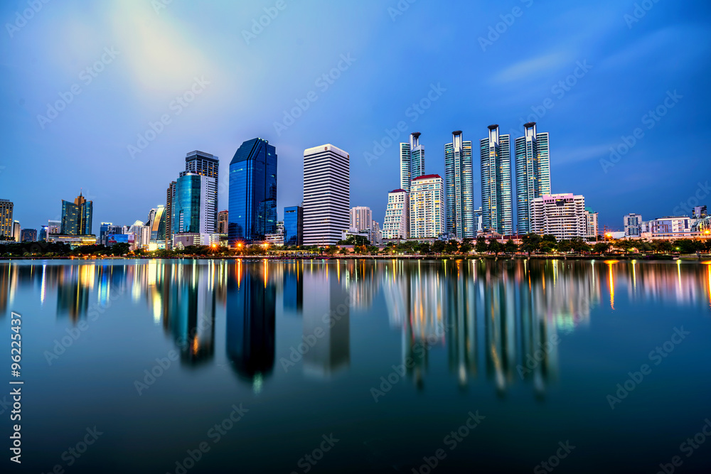 Panorama of Bangkok city downtown at twilight with reflection sk