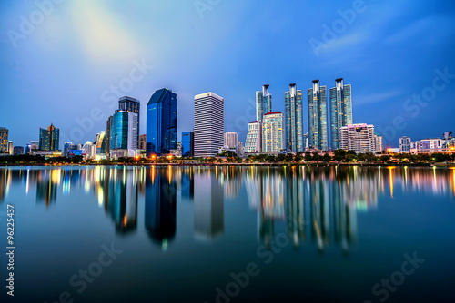 Panorama of Bangkok city downtown at twilight with reflection sk