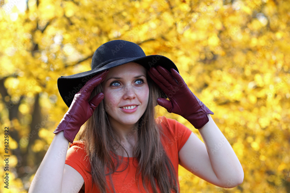 Young woman in autumn wearing gloves and a hat Young woman in autumn wearing gloves and a hat