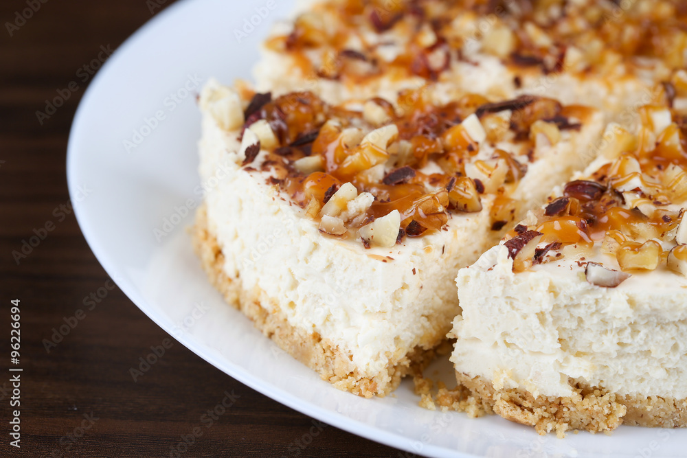 Homemade coconut cheesecake with caramel and assorted nuts