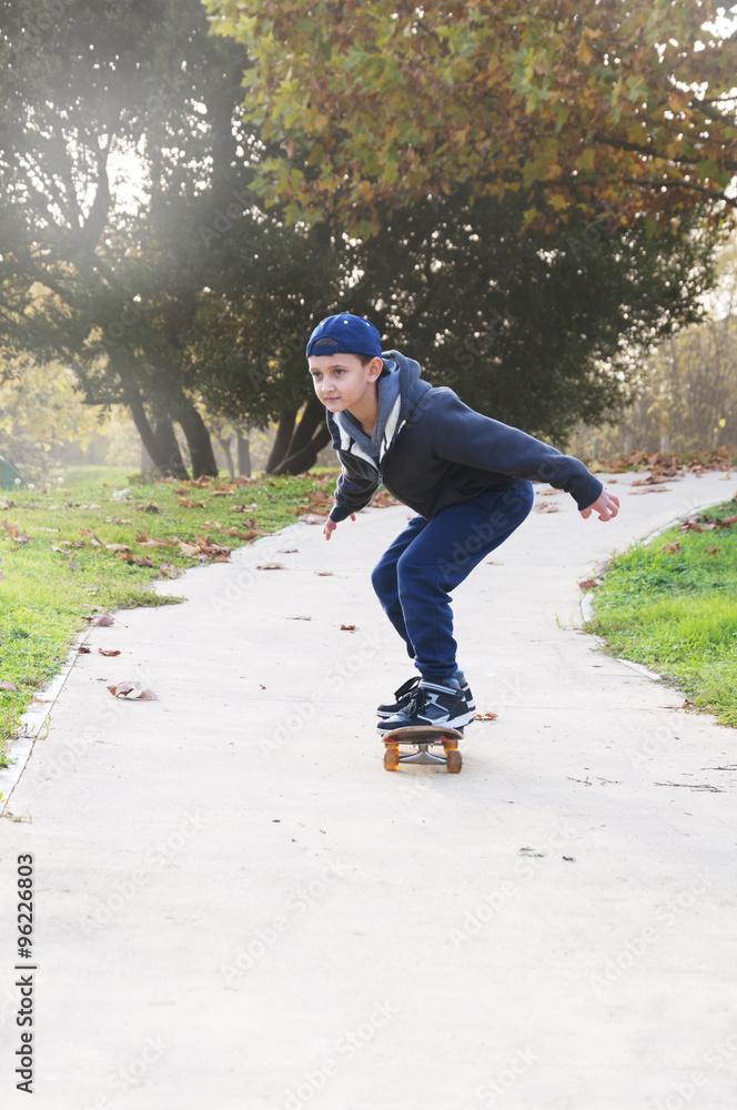 Fototapeta premium boy rides a skateboard in the park